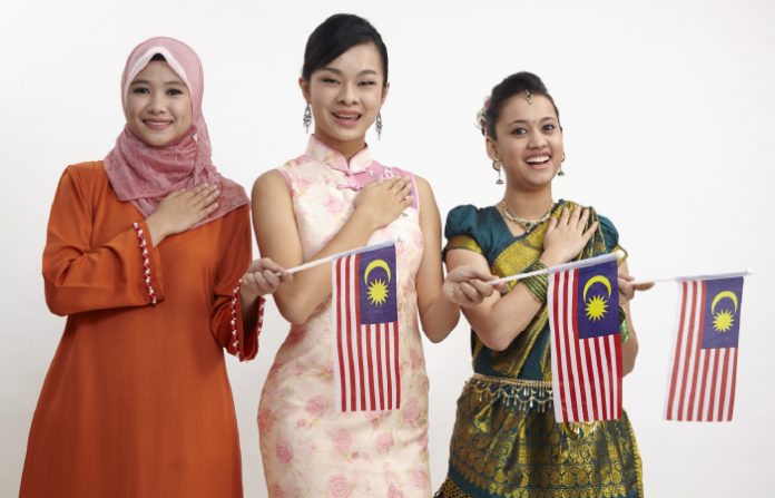 Malaysian women greeting with Malaysian flag
